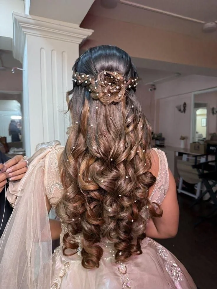 Long curled half-up occasion hairstyle with pearl details